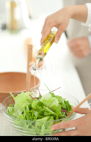 Hand making salad Stock Photo