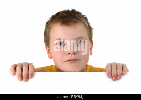 Small boy looking out of a blank whiteboard isolated on white Stock Photo