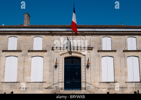 Hotel de Ville (Town Hall) with French flag, St Emilion, Bordeaux region, France Stock Photo