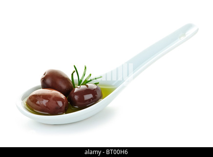 Kalamata olives in olive oil and herbs on spoon Stock Photo