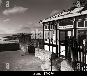 The entrance to the derelict Birnbeck Pier with the pier and Birnbeck Island seen in the distance. Weston-super-Mare, Somerset, England. Stock Photo