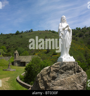 Statue of the Virgin Mary in front of Chapel near castle of Alleuze in Cantal, Auvergne, France, Europe. Stock Photo