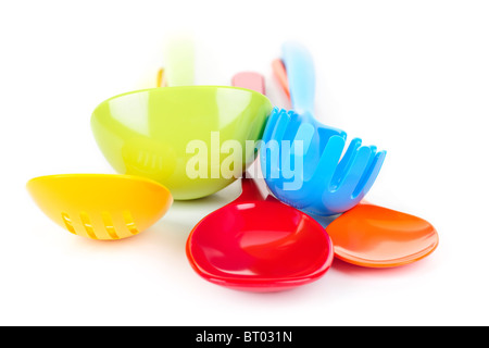 Various colorful plastic kitchen utensils on white background Stock Photo