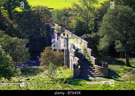 Walkers on Barden Bridge over the River Wharfe near Bolton Abbey, Yorkshire Dales National Park, North Yorkshire, England, UK. Stock Photo