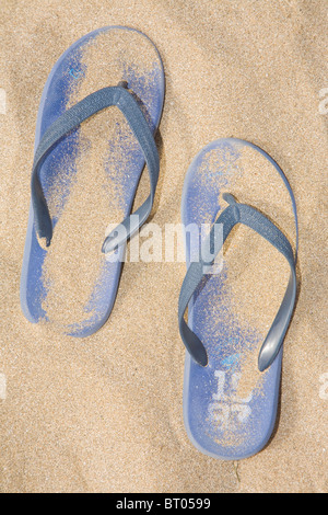 Blue thongs on the beach. Stock Photo