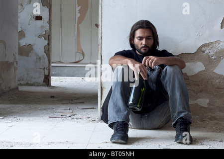 Alcoholic Sitting on the Floor Stock Photo