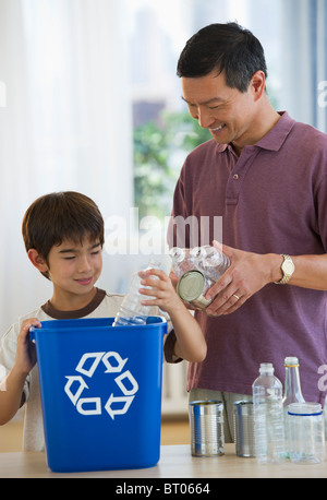 Father and son recycling plastic bottles and tin cans Stock Photo