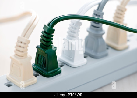Many wires plugged into electric power bar Stock Photo