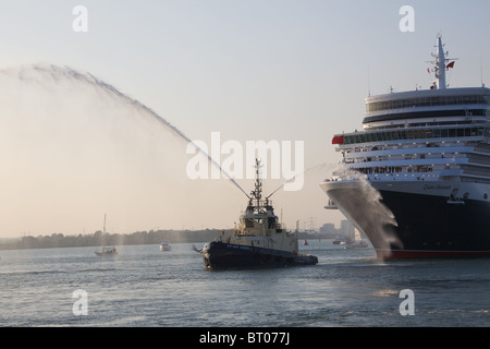 Tug pulling ocean liner from it's dock. Stock Photo