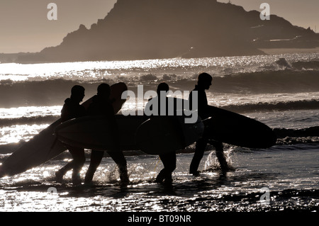 Silhouette of surfers on the beach  at Crescent Beach California Stock Photo