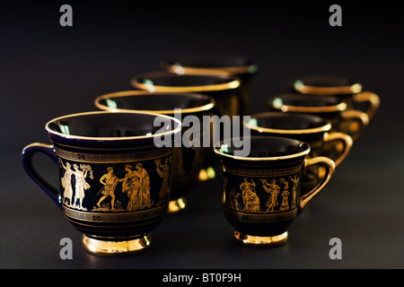 coffee cups with ancient greeks theme lined up on black background Stock Photo