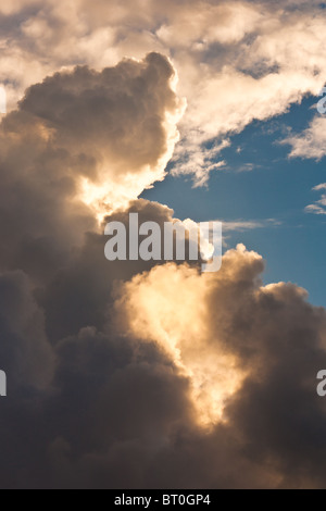 White towering clouds against blue sky at sunset Stock Photo