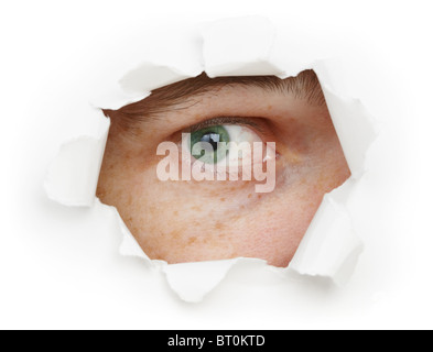 The human eye is watching us through a hole Stock Photo