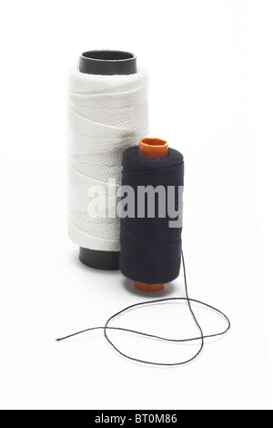 Black and white bobbins of threads on isolated background Stock Photo