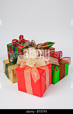 christmas gift boxes wrapped in themed craft paper and satin red bow ...
