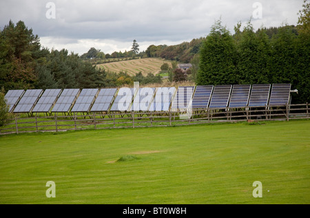 Large array solar PV panels on metal frame in field UK still delivery full power after 28 years UK Stock Photo