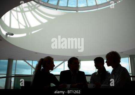 Silhouette of business people interacting with each other Stock Photo