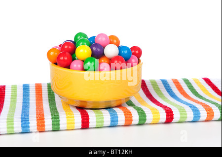 A bowl of colorful gum balls on a vibrant napkin. Stock Photo