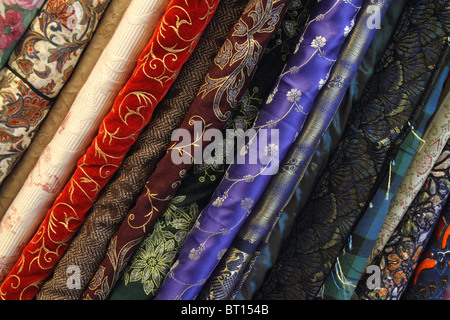 Colorful and elegant bolts of velvet and silk fabric cloth in seamstress shop Stock Photo
