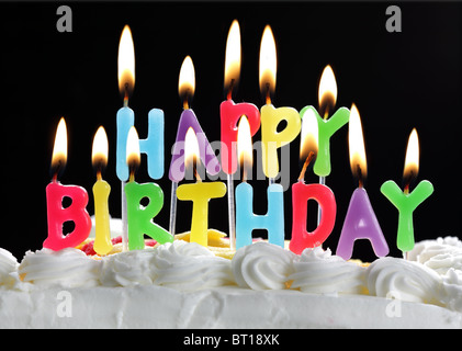 Happy birthday candles on a cake Stock Photo
