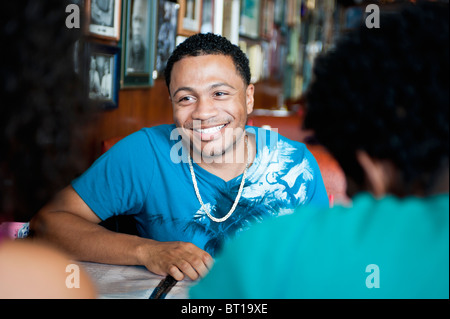 Smiling friends sitting in diner Stock Photo