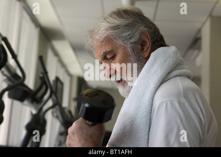 Physically fit and health conscious senior man working out with dumbbell in gym, October 13, 2010 Stock Photo