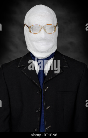 Businessman - mummy in spectacles on the black background Stock Photo