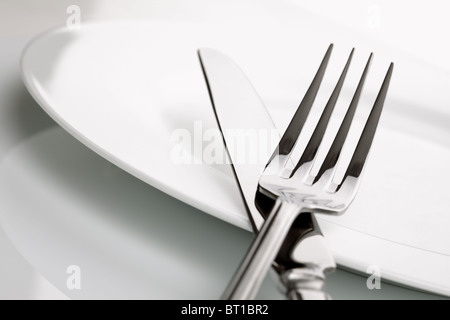 Dinner plate, knife and fork silverware Stock Photo