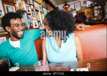 Smiling couple sitting in diner booth Stock Photo