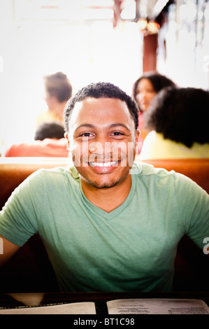 Smiling mixed race man in diner Stock Photo