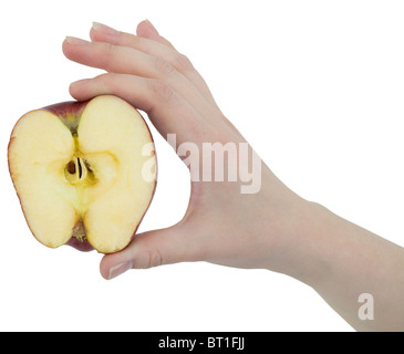 Cut apple in a female hand on white background Stock Photo