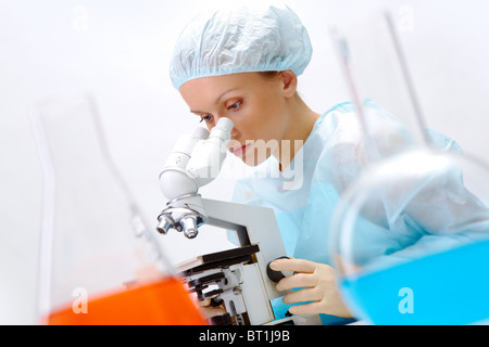 Portrait of medical student looking through microscope in laboratory