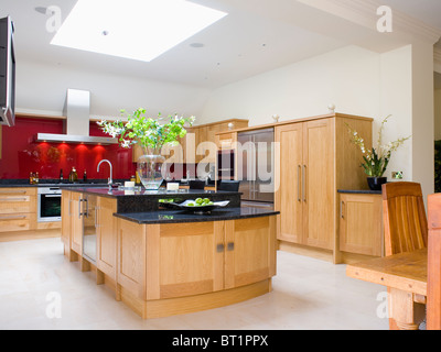 Limestone Flooring In Large Modern Kitchen Extension With Black Granite Worktop On Pale Wood Island Unit Limestone Flooring In Large Modern Kitchen Extension With Black Granite Worktop On Pale Wood Island Unit