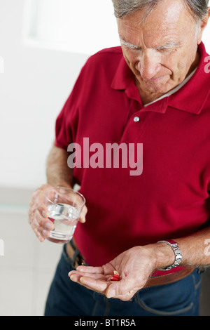 senior man taking medicine Stock Photo