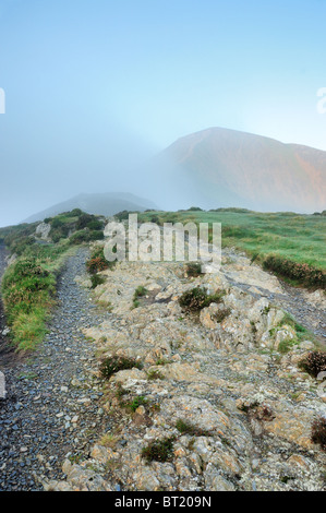 Footpath through the mist to the summit of Grisedale Pike in the English Lake District Stock Photo