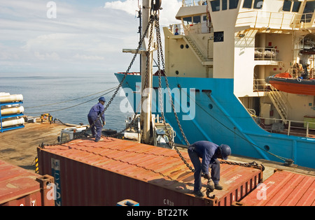 Luba Oil Freeport. Stevedores loading containers onto ship from quayside at port Stock Photo