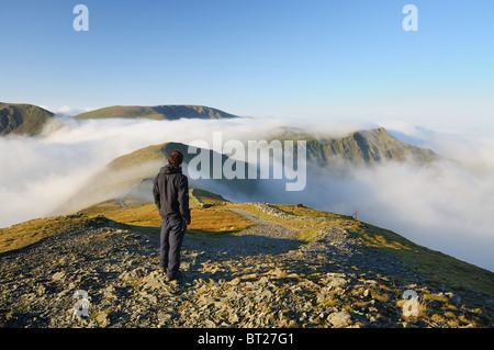 Walker above the cloud on Grisedale Pike in the English Lake District Stock Photo