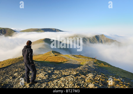 Walker above the cloud on Grisedale Pike in the English Lake District Stock Photo