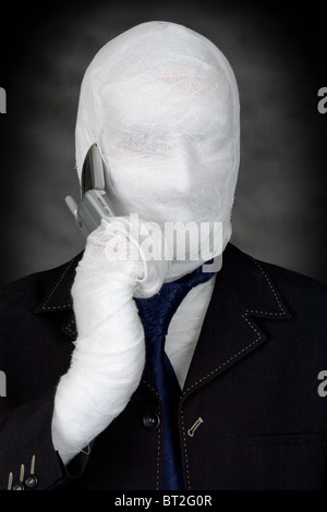 Mummy-businessman talking on telephone on the black background Stock Photo