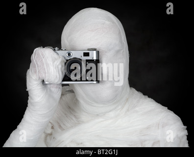 Photographer - mummy on the black background isolated Stock Photo