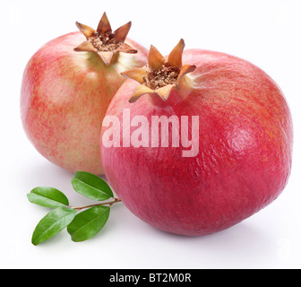 Juicy pomegranates with leaves. Isolated on a white background. Stock Photo