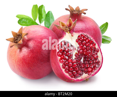Juicy opened pomegranate with leaves. Isolated on a white background. Stock Photo