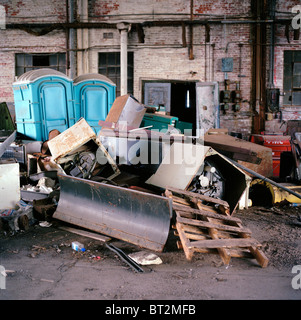 Trash and debris in an old airplane hanger Stock Photo