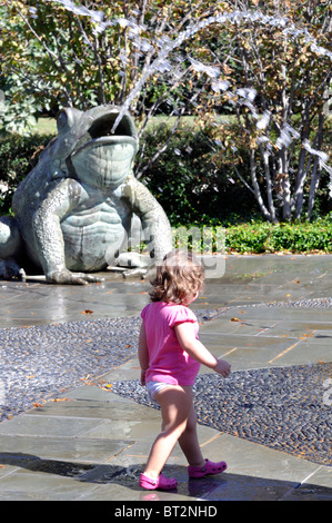 Child playing in Frog fountain, Dallas Arboretum, Texas, USA Stock Photo