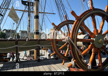 Steering wheel on deck aboard the Grand Turk, a three-masted frigate at Saint Malo, Brittany, France Stock Photo
