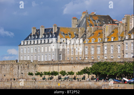 Tourists at the quay and walking on the town ramparts at Saint-Malo, Brittany, France Stock Photo