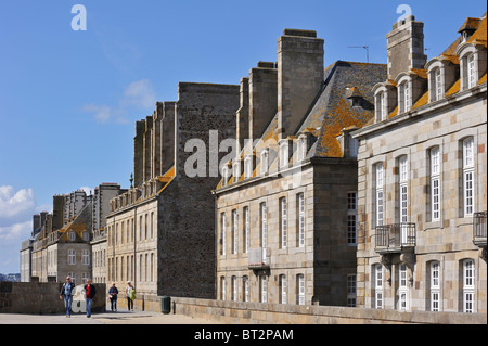 Tourists walking on the town ramparts and typical houses at Saint-Malo, Brittany, France Stock Photo