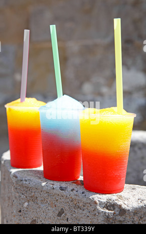 crushed ice drinks with straws in hands Stock Photo - Alamy