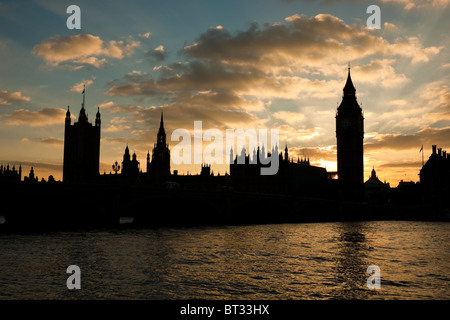 Houses of parliament and Big Ben in silhouette at sunset with moody sky Stock Photo