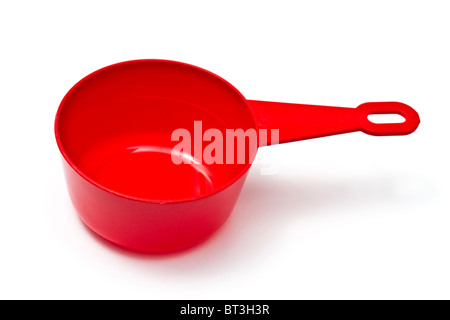 Red plastic measuring cup isolated on white background Stock Photo